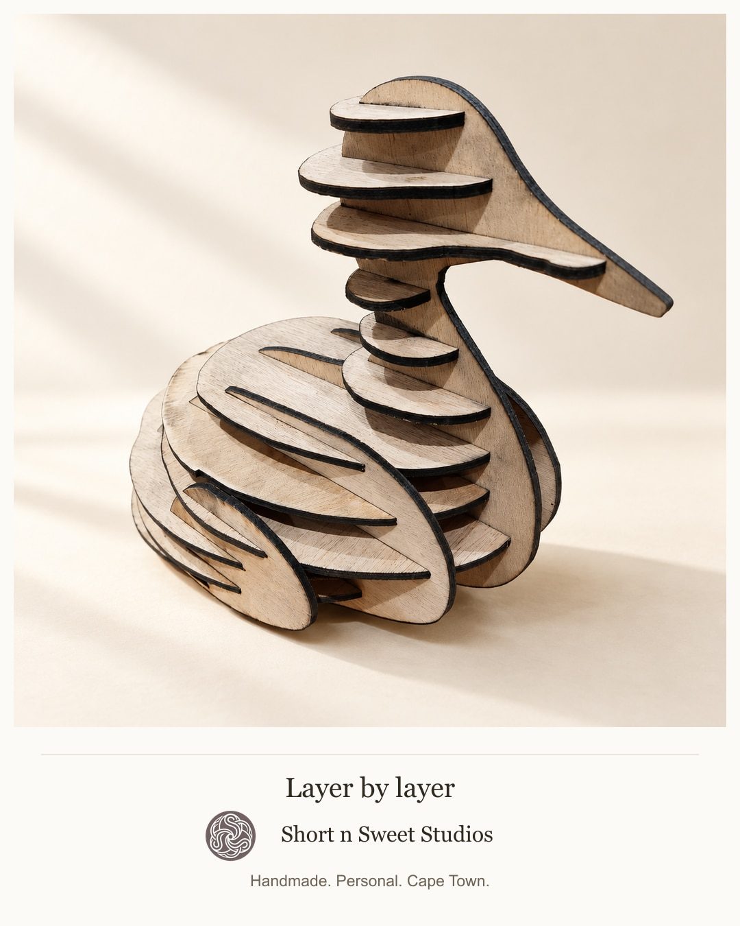 Wooden duck puzzle and decorative laser-cut piece made in the studio.